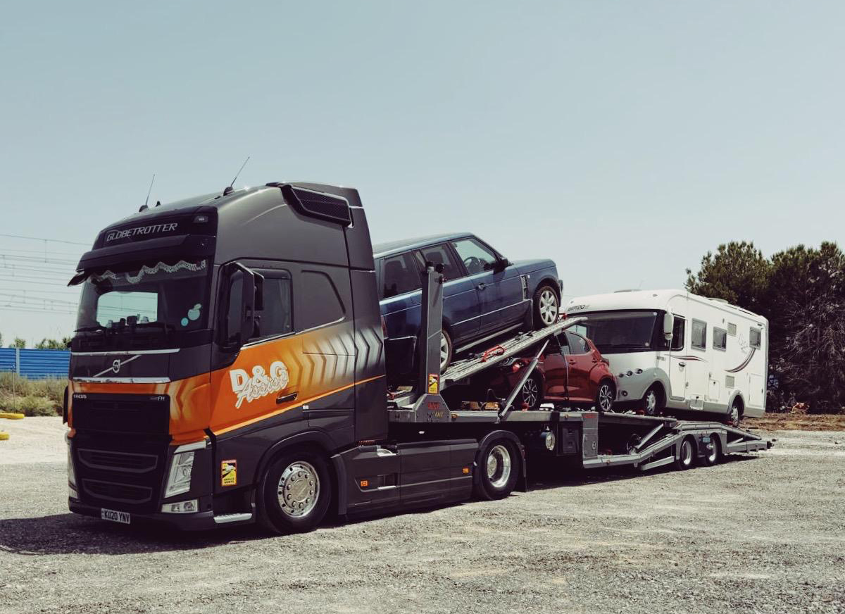D&G car transporter carrying cars and a motorhome