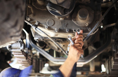 D&G Assist technician carrying out diagnostic repair work underneath a vehicle