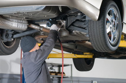 D&G Assist technician preparing a car for MOT on a workshop lift